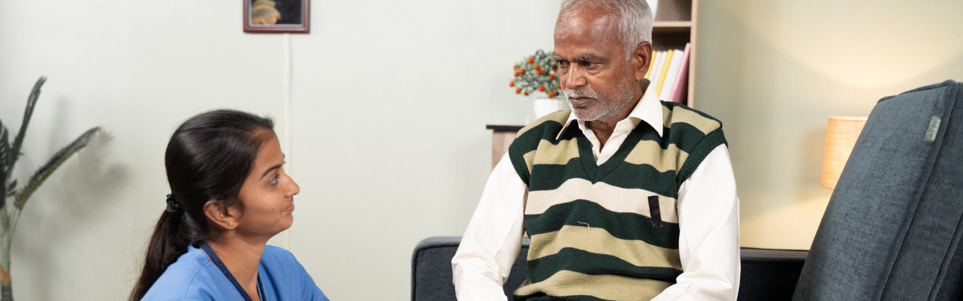 caregiver and elderly man looking at each other