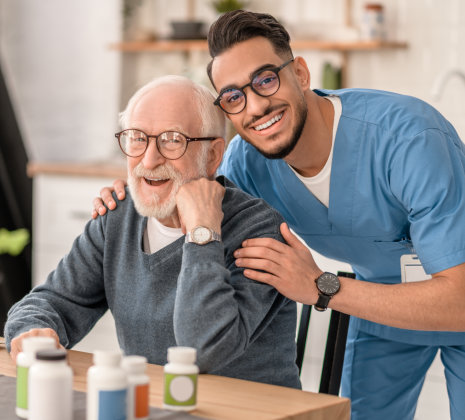 caregiver and elderly man both wearing glasses