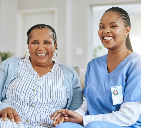 caregiver and elderly woman sitting in the living room