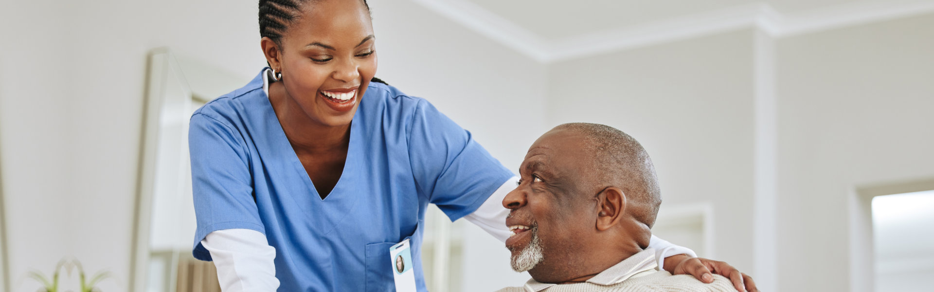 caregiver and elderly man talking