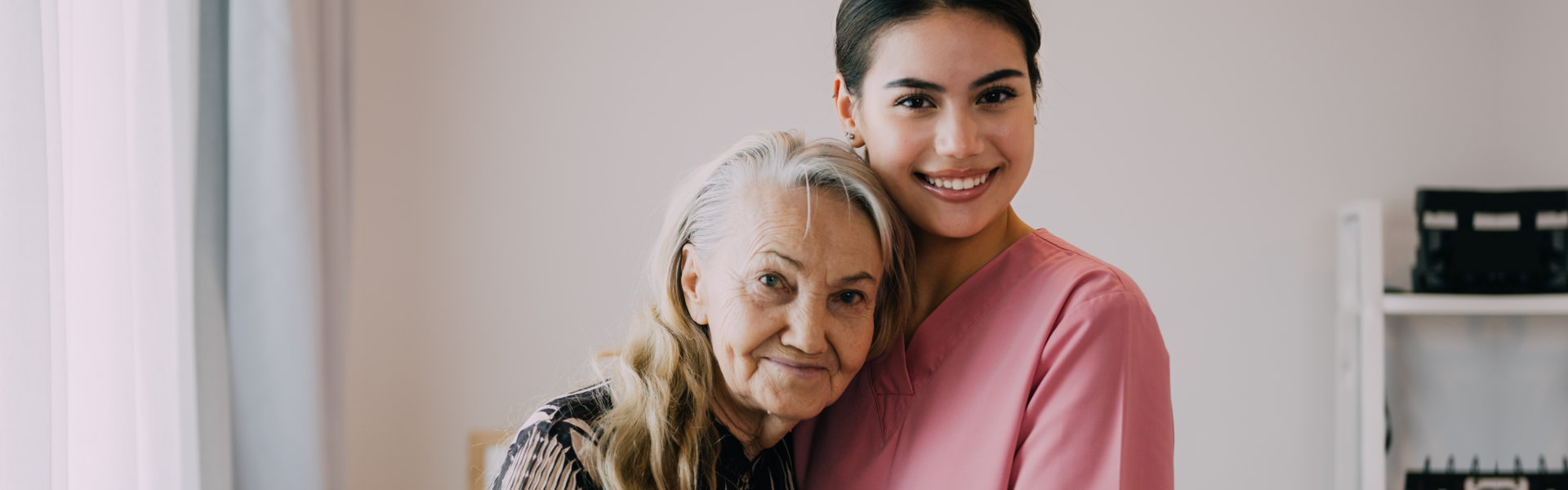 caregiver embracing the elderly woman