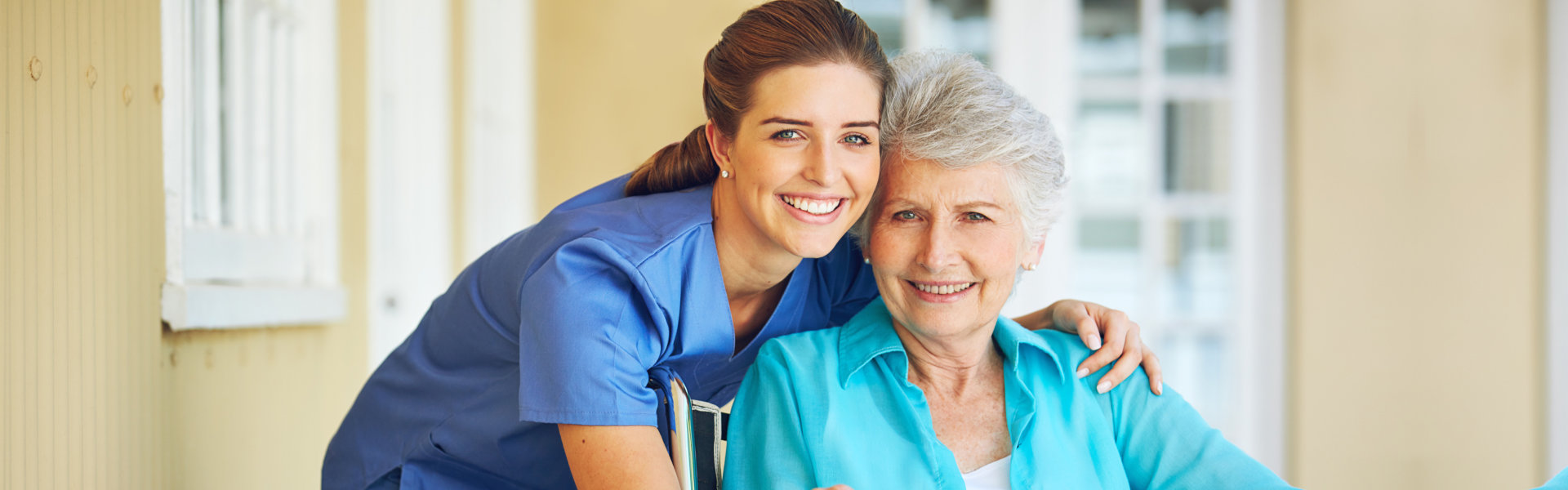 caregiver and elderly woman in a wheelchair