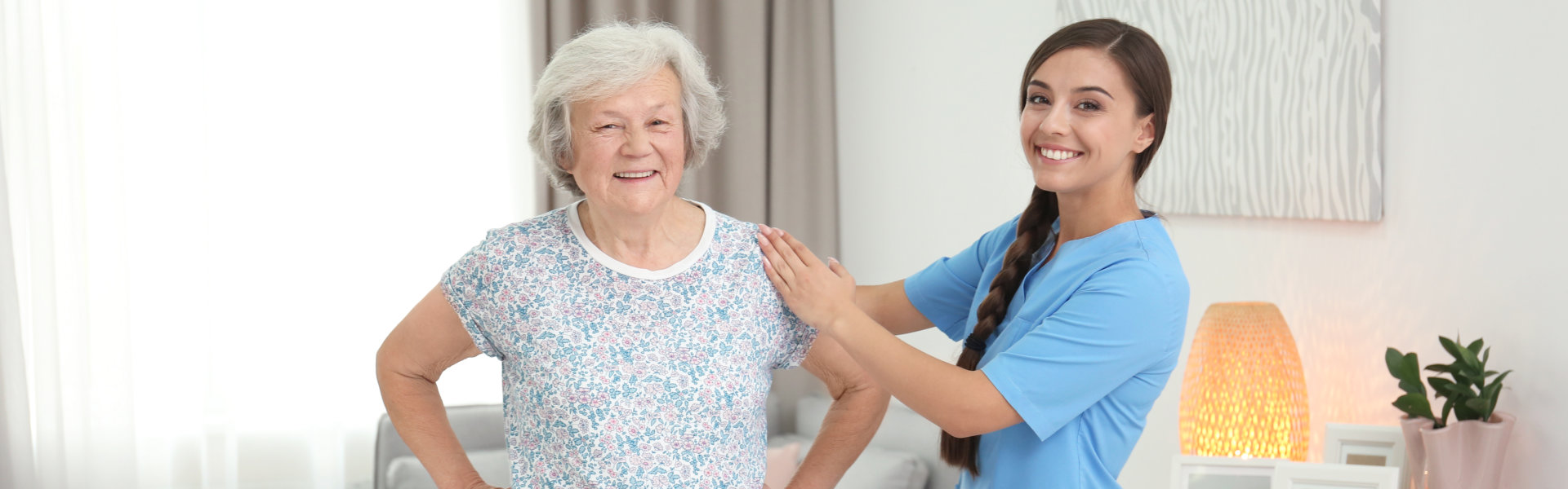 caregiver holding the elderly woman's shoulder